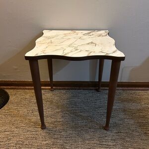 vintage end table featuring a faux marble top and spindle legs